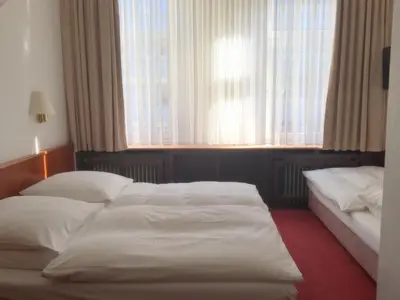 Ein Bett oder Betten in einem Zimmer der Unterkunft Hotel Bismarck