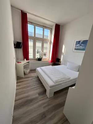 Ein Bett oder Betten in einem Zimmer der Unterkunft Hotel Astor