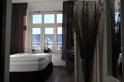 Ein Bett oder Betten in einem Zimmer der Unterkunft Hotel Astor