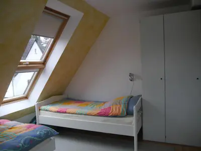 Ein Bett oder Betten in einem Zimmer der Unterkunft FeWo BlumenPott
