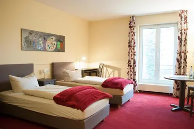 Ein Bett oder Betten in einem Zimmer der Unterkunft Gästehaus Alte Schule
