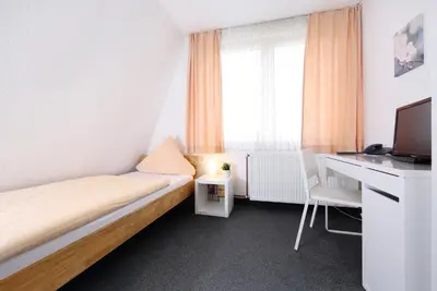 Ein Bett oder Betten in einem Zimmer der Unterkunft Hotel Garni Schilling