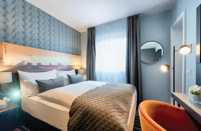 Ein Bett oder Betten in einem Zimmer der Unterkunft Leonardo Boutique Hotel Düsseldorf