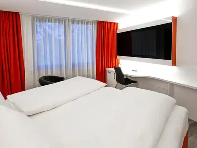 Ein Bett oder Betten in einem Zimmer der Unterkunft DORMERO Hotel Düsseldorf