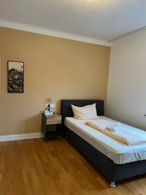 Ein Bett oder Betten in einem Zimmer der Unterkunft Stadthotel Reckers