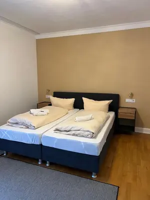 Ein Bett oder Betten in einem Zimmer der Unterkunft Stadthotel Reckers