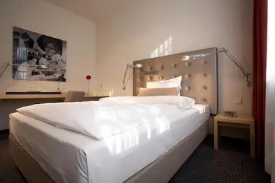 Ein Bett oder Betten in einem Zimmer der Unterkunft Hotel Maximilians