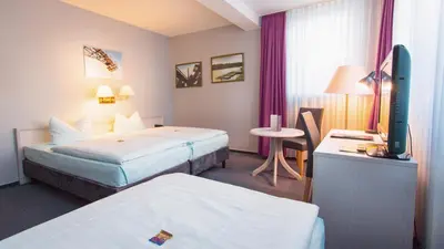 Ein Bett oder Betten in einem Zimmer der Unterkunft Excelsior Bochum