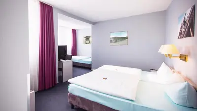 Ein Bett oder Betten in einem Zimmer der Unterkunft Excelsior Bochum