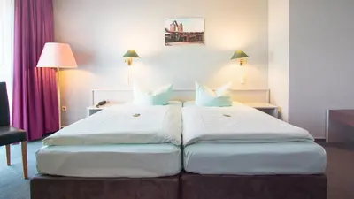 Ein Bett oder Betten in einem Zimmer der Unterkunft Excelsior Bochum
