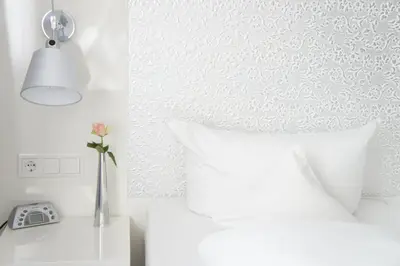 Ein Bett oder Betten in einem Zimmer der Unterkunft Business Wieland Hotel