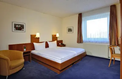 Ein Bett oder Betten in einem Zimmer der Unterkunft Hotel Haus Kronenthal