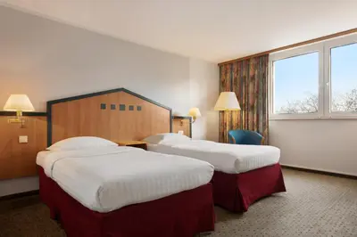 Ein Bett oder Betten in einem Zimmer der Unterkunft Ramada by Wyndham Bottrop City