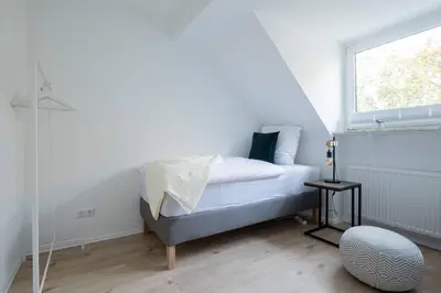 Ein Bett oder Betten in einem Zimmer der Unterkunft cruwzo I Apartments am Uniklinikum