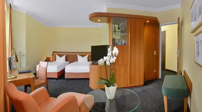 Ein Bett oder Betten in einem Zimmer der Unterkunft Ringhotel Parkhotel Witten
