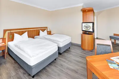 Ein Bett oder Betten in einem Zimmer der Unterkunft Ringhotel Parkhotel Witten