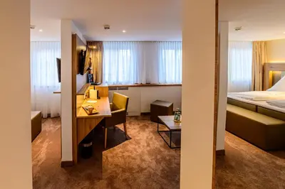 Ein Bett oder Betten in einem Zimmer der Unterkunft Landhotel Jagdschlösschen