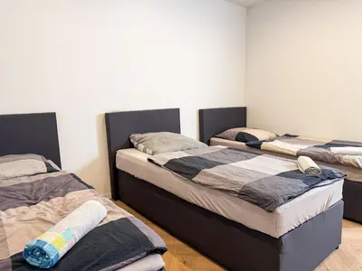 Ein Bett oder Betten in einem Zimmer der Unterkunft Ruhr Business Apartments Essen Apartment mit 5 Einzelbetten Privat Parkplatz