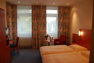 Ein Bett oder Betten in einem Zimmer der Unterkunft Astoria Hotel