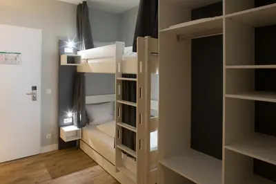 Ein Bett oder Betten in einem Zimmer der Unterkunft Weberei Bendix Hotel & Appartements