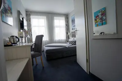 Ein Bett oder Betten in einem Zimmer der Unterkunft Hotel Stadt Lüdenscheid
