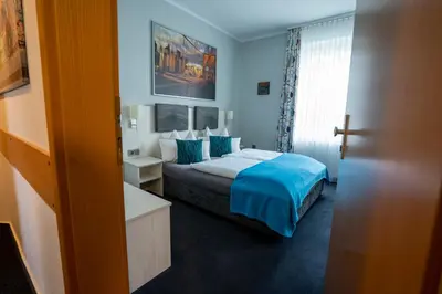 Ein Bett oder Betten in einem Zimmer der Unterkunft Hotel Stadt Lüdenscheid