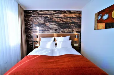 Ein Bett oder Betten in einem Zimmer der Unterkunft Ascot Hotel