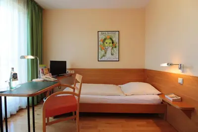 Ein Bett oder Betten in einem Zimmer der Unterkunft An der Persiluhr Stadt-gut-Hotel