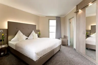 Ein Bett oder Betten in einem Zimmer der Unterkunft Ringhotel Am Stadtpark