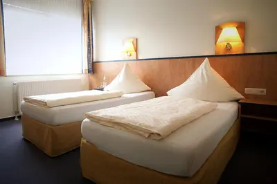 Ein Bett oder Betten in einem Zimmer der Unterkunft Hotel Haus Union