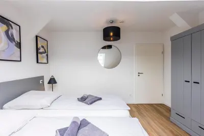 Ein Bett oder Betten in einem Zimmer der Unterkunft Glück Auf Appartements Kaiserstraße Mülheim