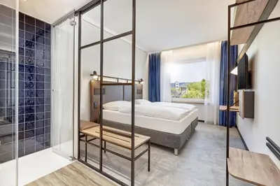 Ein Bett oder Betten in einem Zimmer der Unterkunft H2 Hotel Düsseldorf City