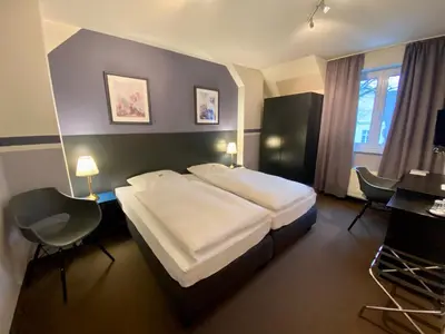 Ein Bett oder Betten in einem Zimmer der Unterkunft Hotel Kaiserswerth