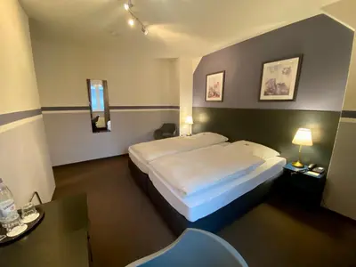 Ein Bett oder Betten in einem Zimmer der Unterkunft Hotel Kaiserswerth