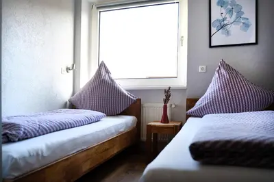 Ein Bett oder Betten in einem Zimmer der Unterkunft Hotel Garni Moers