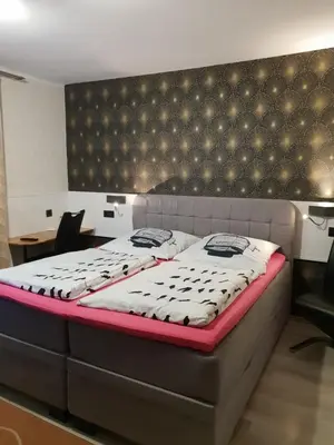 Ein Bett oder Betten in einem Zimmer der Unterkunft Waldhotel Lemberg