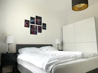 Ein Bett oder Betten in einem Zimmer der Unterkunft JayBnB - Gaming Apartment PS5 65 Zoll 4K TV Wohnung mit Balkon