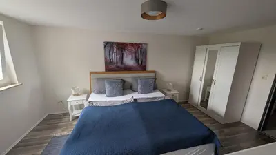 Ein Bett oder Betten in einem Zimmer der Unterkunft SauerlandBlick Ferienwohnung