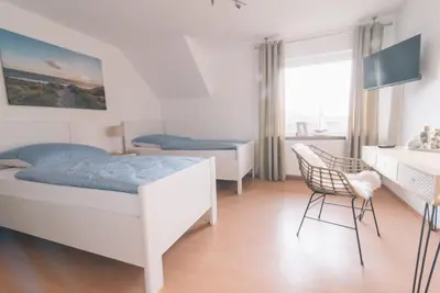 Ein Bett oder Betten in einem Zimmer der Unterkunft Ferienwohnung In den Wiesen