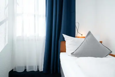 Ein Bett oder Betten in einem Zimmer der Unterkunft Hotel Das Kemperdick