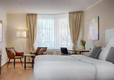 Ein Bett oder Betten in einem Zimmer der Unterkunft Hotel Am Brinkerplatz